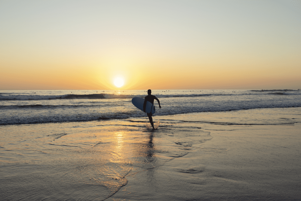 Ryan surfing in the ocean at sunset on Costa Rica's Pacific Coast