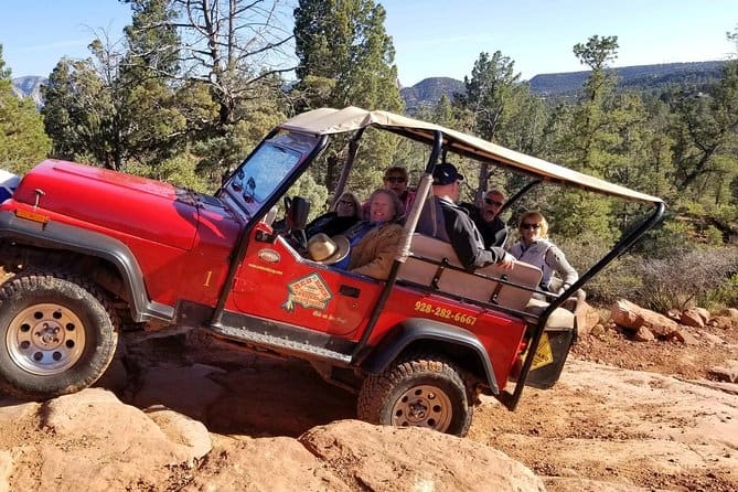 Old Bear Wallow jeep to tour for seniors from Sedona. Red Rock Outfitters climbing a steep hill.