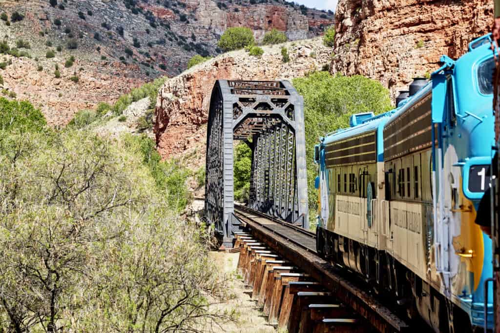 Verde Canyon Railcar passing over a bridge, it's a great option for sightseeing in Sedona with elderly parents