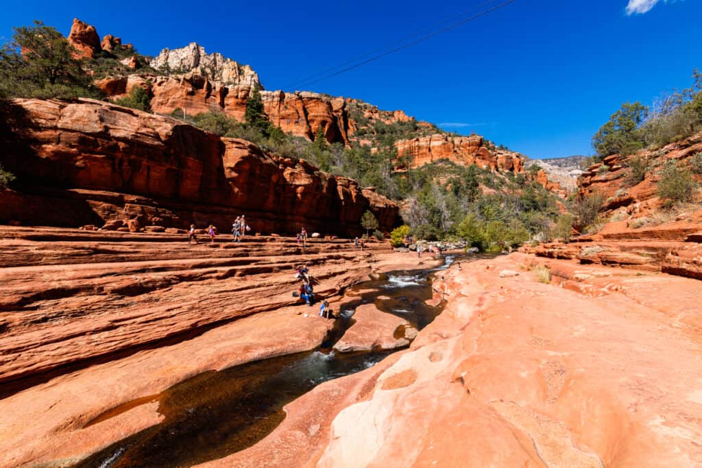 Coconino, Arizona USA - October 17, 2016: Visitors enjoying the beauty of Slide Rock State Park with its natural rock water slides in the Oak Creek Canyon near Sedona