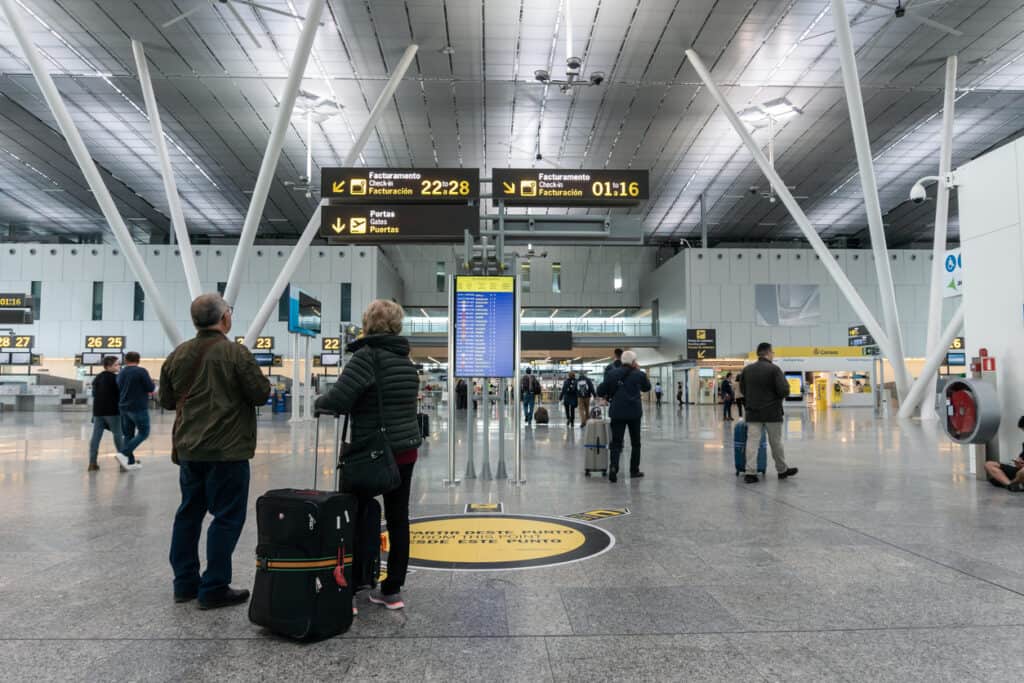 Older couple at an international airport waiting to begin their cultural immersion experiences.