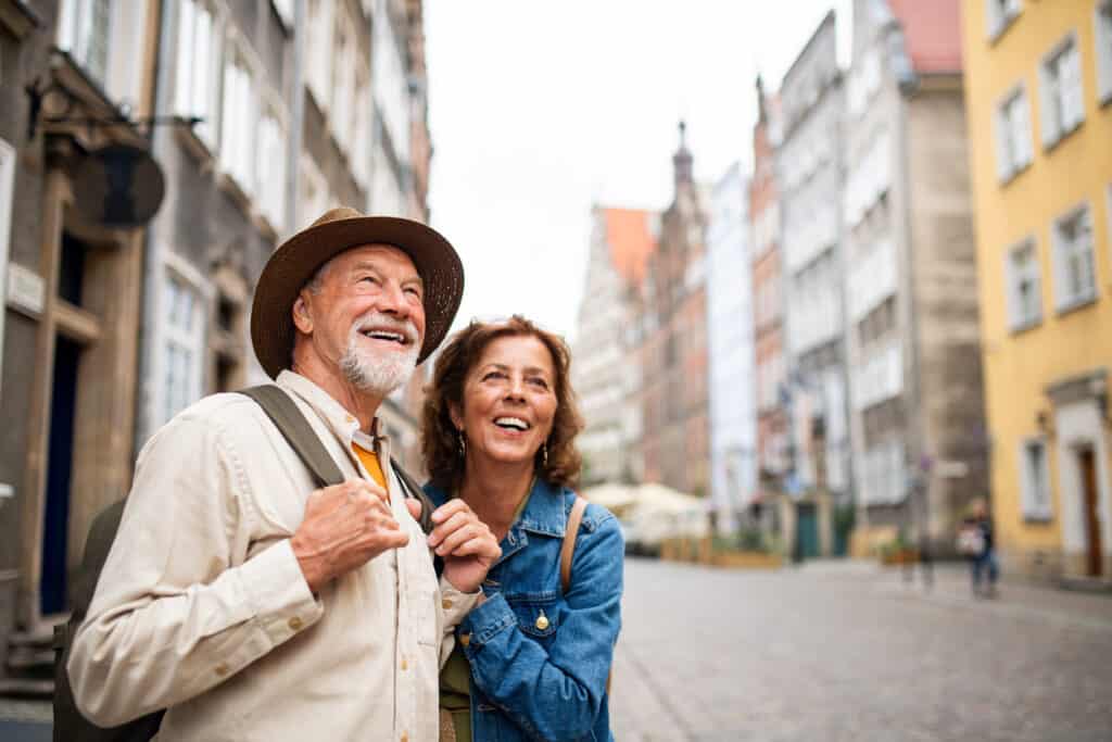 older couple enjoying a cultural immersion experience outdoors in a historic town.