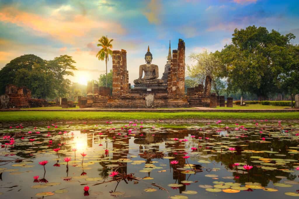 Wat Mahathat Temple in the precinct of Sukhothai Historical Park, a UNESCO World Heritage Site in Thailand. Learning about the country's spiritual practice is a large part of any cultural immersion experience