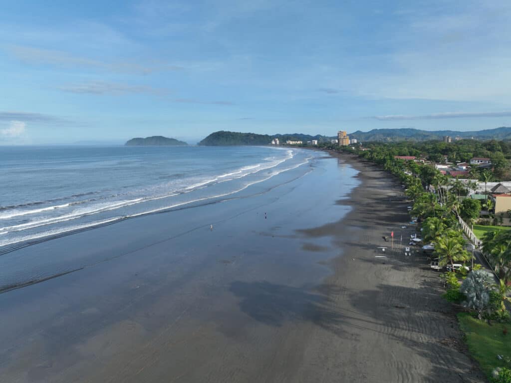 Aerial view of Jaco Beach, Costa Rica from the south side of the beach. View of the beach, town and lush green forests. One of the best beach towns in Costa Rica. Photo, iStock