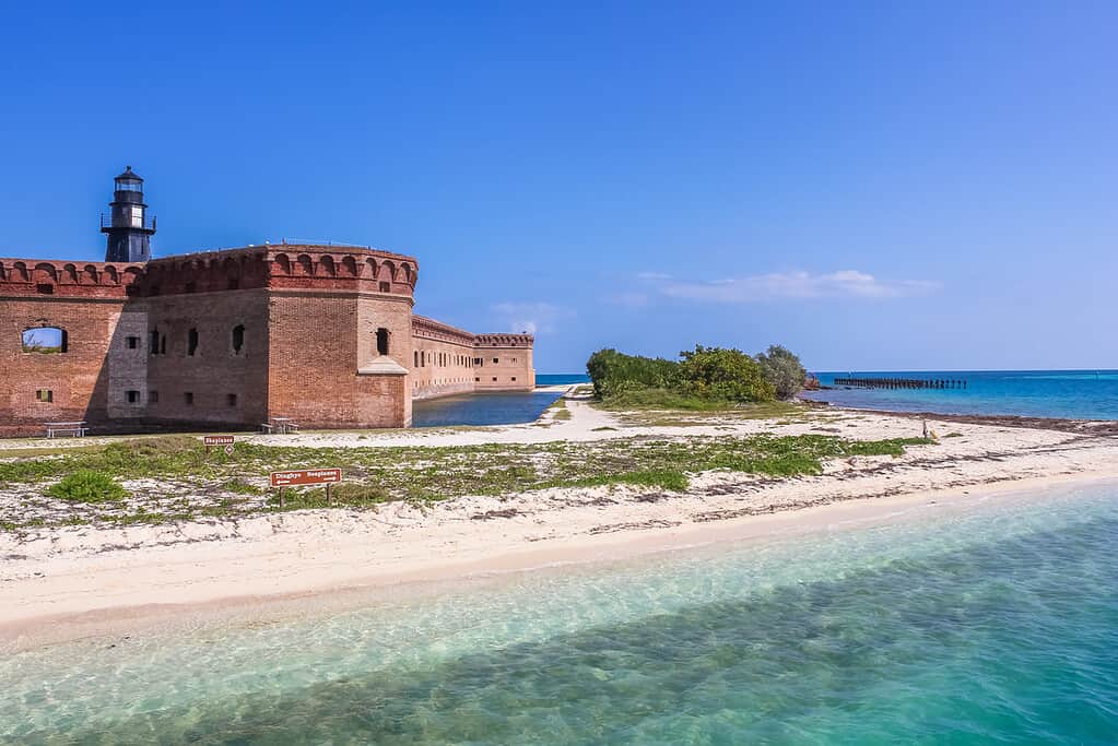 South Coaling Dock Ruins in Fort Jefferson, a historical military fortress, dominated by Garden Key Lighthouse, on Dry Tortugas National Park, Florida, United States. Part of a great Florida tour for Active Seniors.