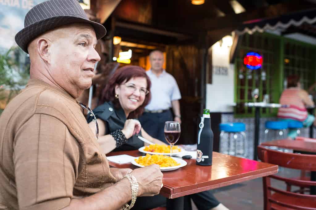 "Miami, FL, USA- July 27, 2012: Mature couple having dinner sitting outside Casa Panza Restaurant in calle ocho, Miami, FL. Calle ocho is famous because the exile cuban community that lives around."