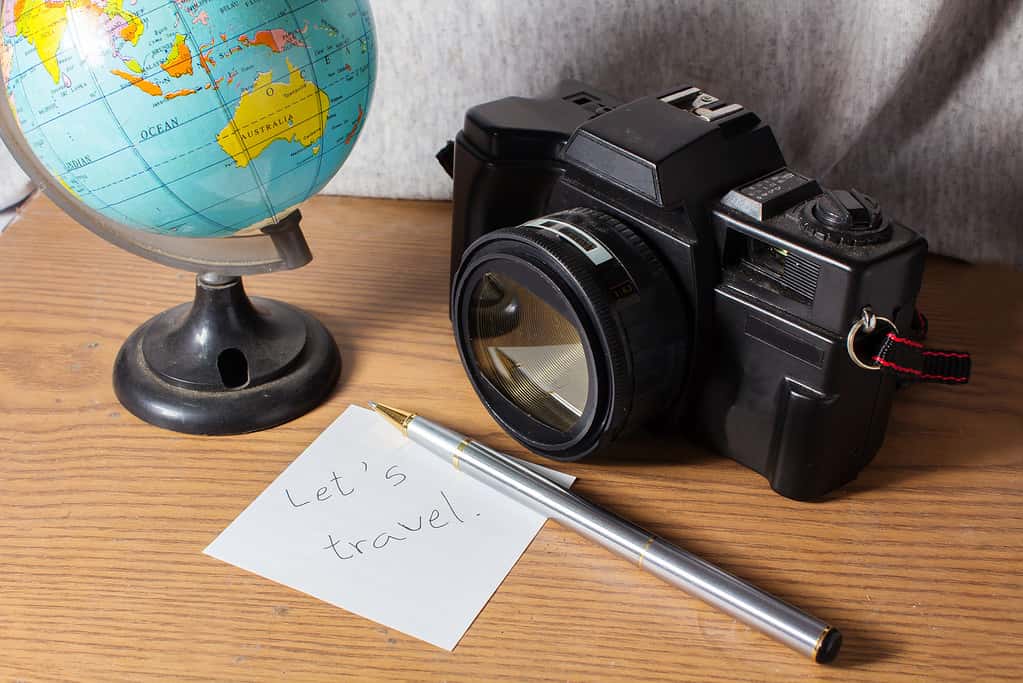 picture of a camera and a globe, symbolizing one of the many hobbies that allow you to travel the world.