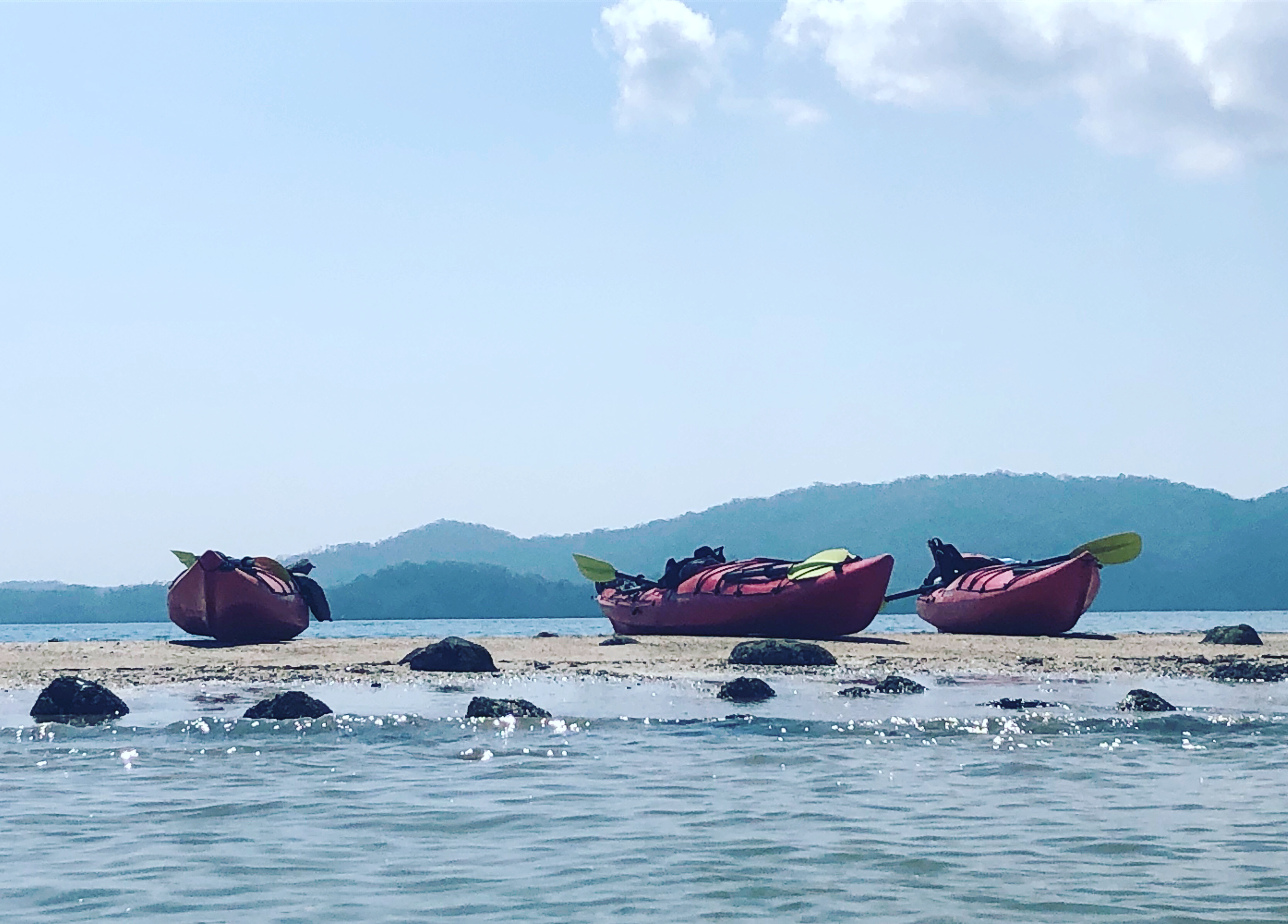 Sea kayaking in Costa Rica via Bahia Rica Tours, show three of their sea kayaks on a shoal.