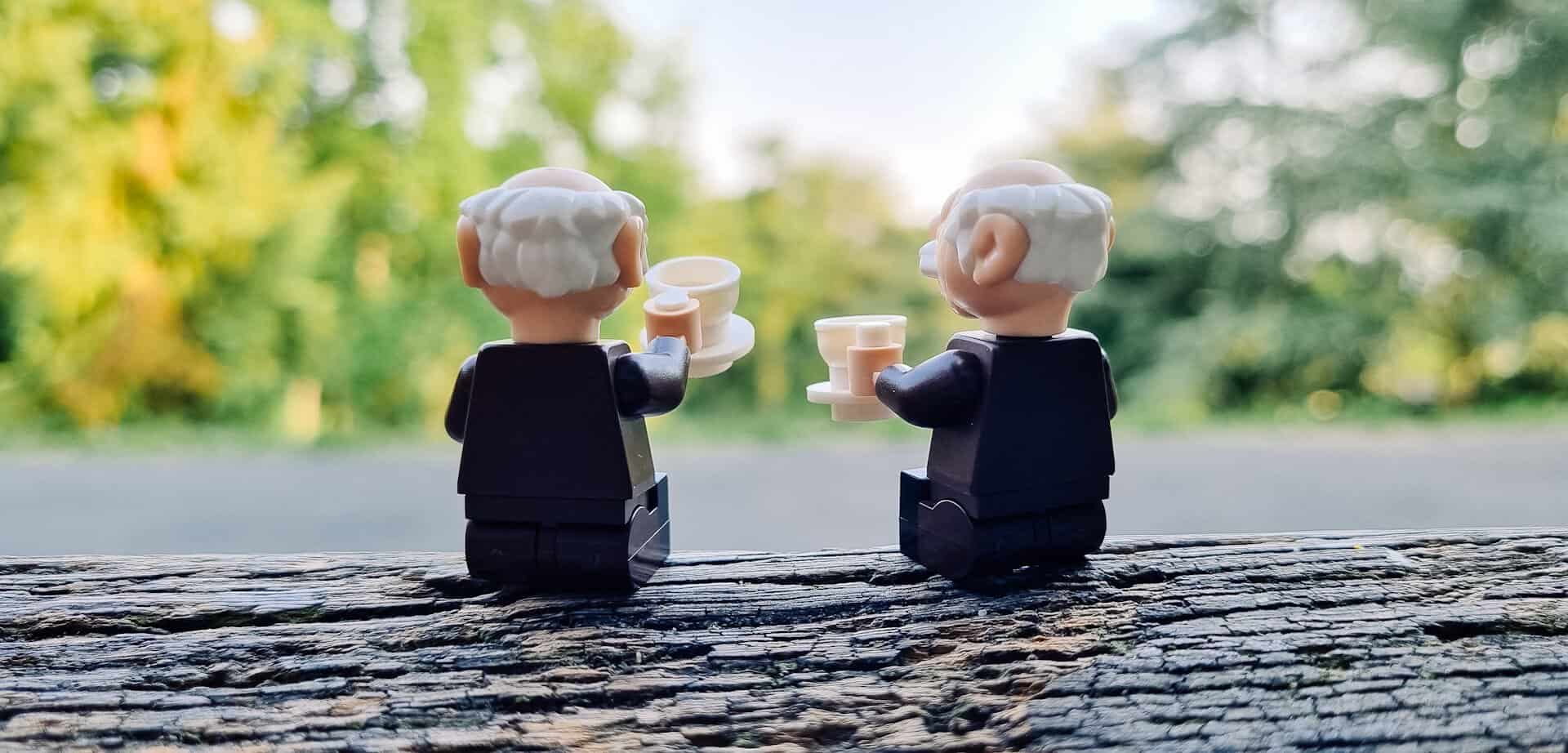 two Lego old guys raising a toast, possible a retirement toast