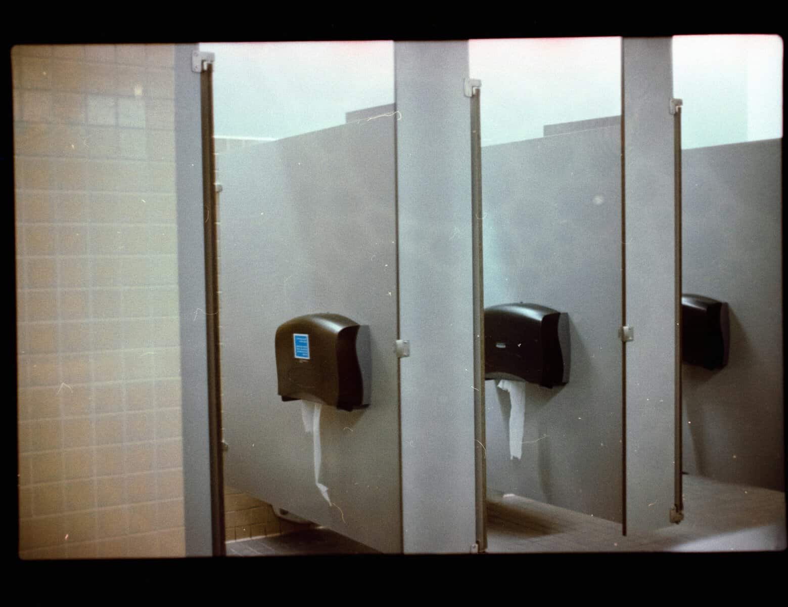 public bathroom etiquette A picture of three bathroom stalls