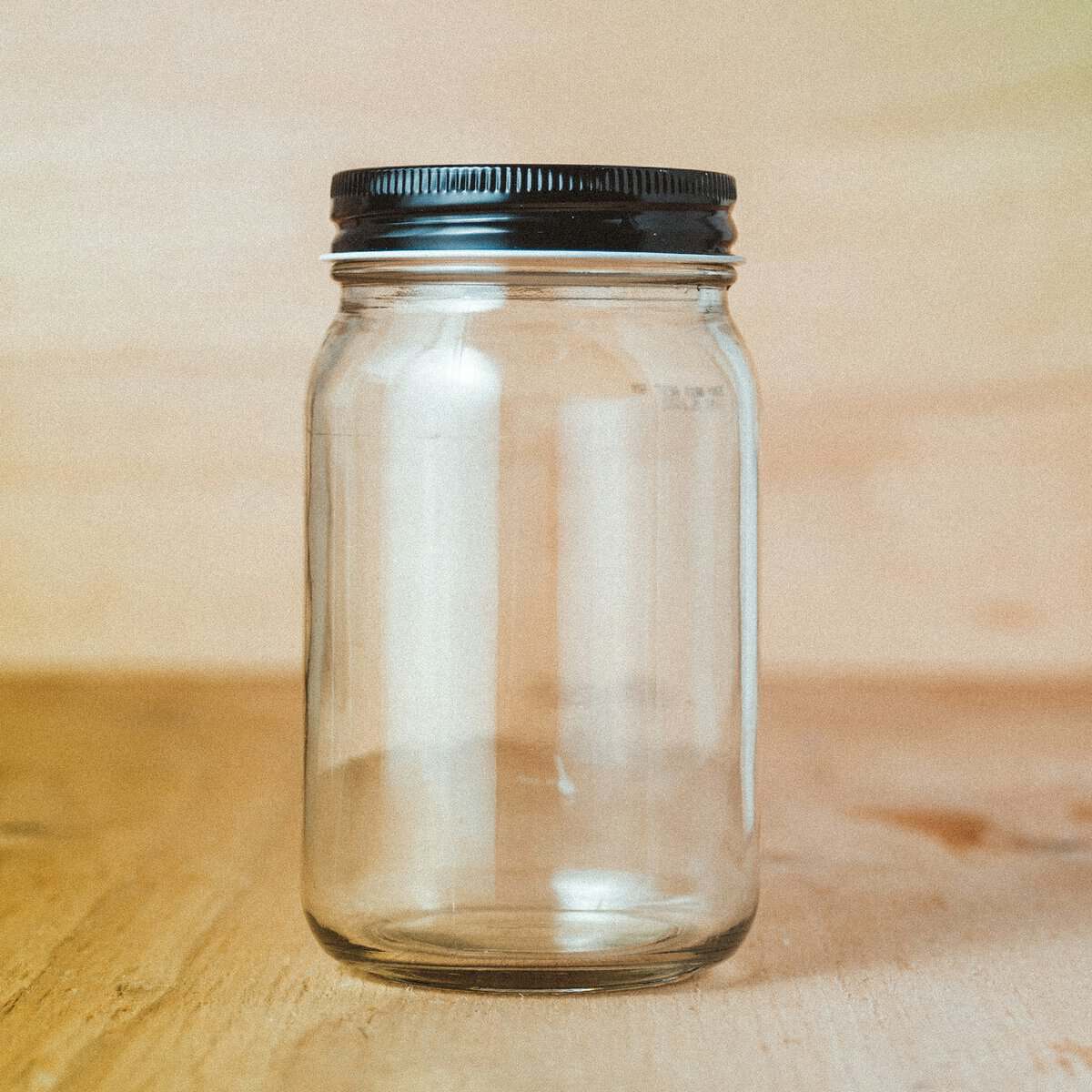 an empty mason style jar with a lid on it for the essay My dad never met a jar he didn't like, and essay about turning into our parents